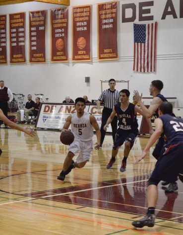 Guard Jeremy Ishimaru (5) drives to the net in the Dons 70-68 win over the Rams. Jeremy led the team in scoring with 20 points. 