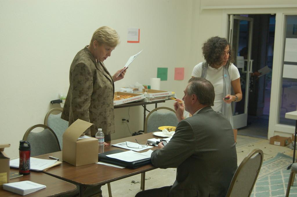 Foothill-De Anza Chancellor Linda Thor (left) and Vice Chancellor of Business Kevin McElroy (middle) converse at the parcel tax campaign headquarters in the Oaks Shopping Center on Sep. 15.