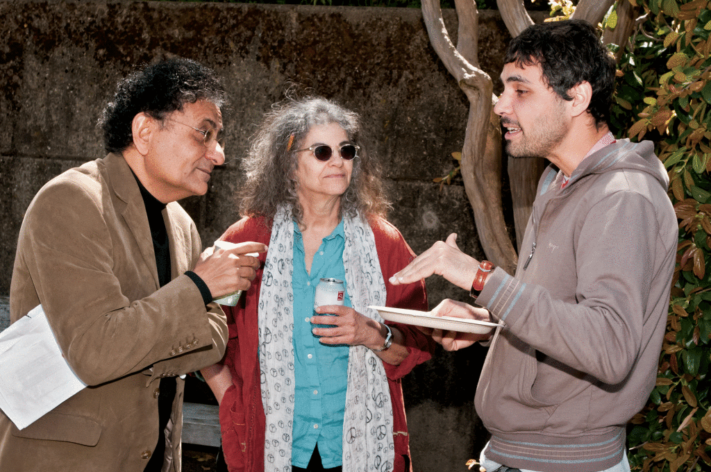 Sociology major Hossein Salehi (right), 31, left his homeland of Iran after winning the lottery; he decided to further his education in America to attend De Anza College. Israeli journalist Ben-Dror Yemini (left) discusses Salehi’s story while journalism department chair and Jews, Israeli’s and Friends Club adviser Beth Grobman (center) listens in on the conversation. 