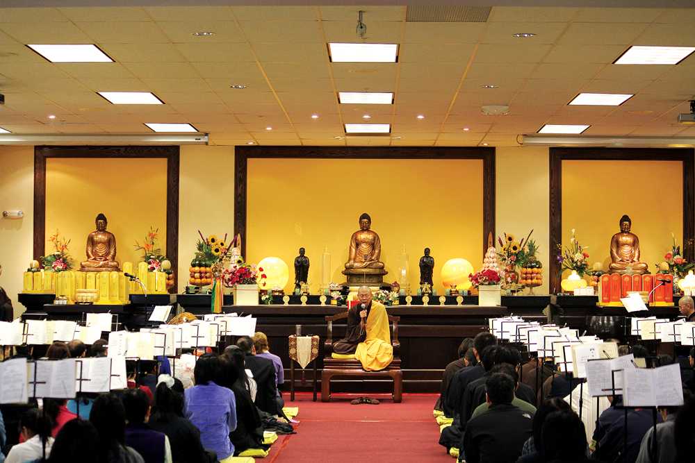 BEGINNING - Master Jian Hu of the Zen center commences the ceremonial bathing of Buddha to commemorate him on his birthday of over 3,000 years