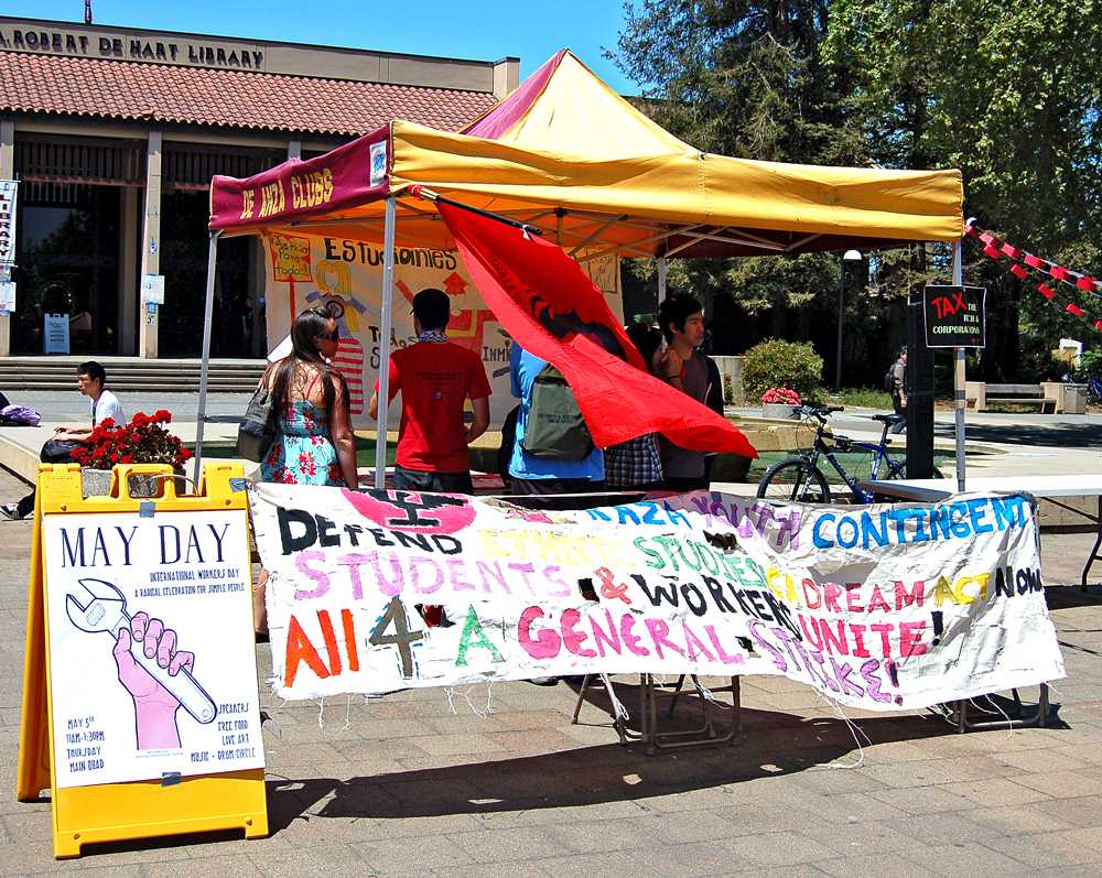 TENT - May Day organizers talk under the tent during the event held May 5 in the Main Quad.