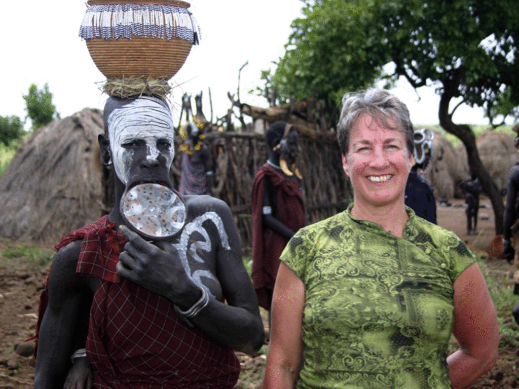 ETHIOPIA - Kristin Jensen Sullivan with a member of the Mursi tribe, inhabitants within Mago National Park, located in Ethiopia.