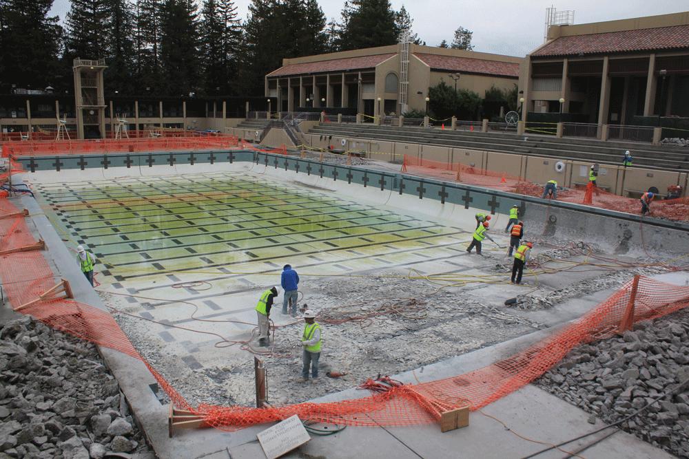 EMPTY POOL - A construction crew begins removing old tile and concrete from the bottom of De Anza’s large pool.  Both pools will remain closed during winter quarter as crews work to replace aging and damaged materials.