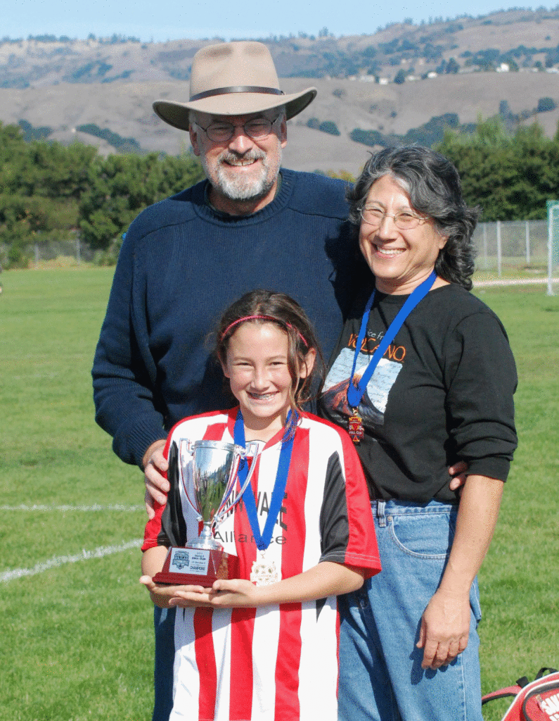 CHARLES HIEBERT (left) - with wife Kathy and daughter Amanda after her soccer team won the District Cup.