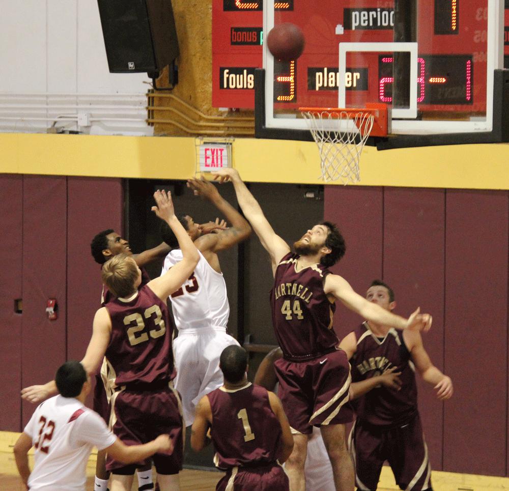 SNAGGING THE REBOUND - Panther players jump at a shot taken by Dons forward Chris Saint-Amand.