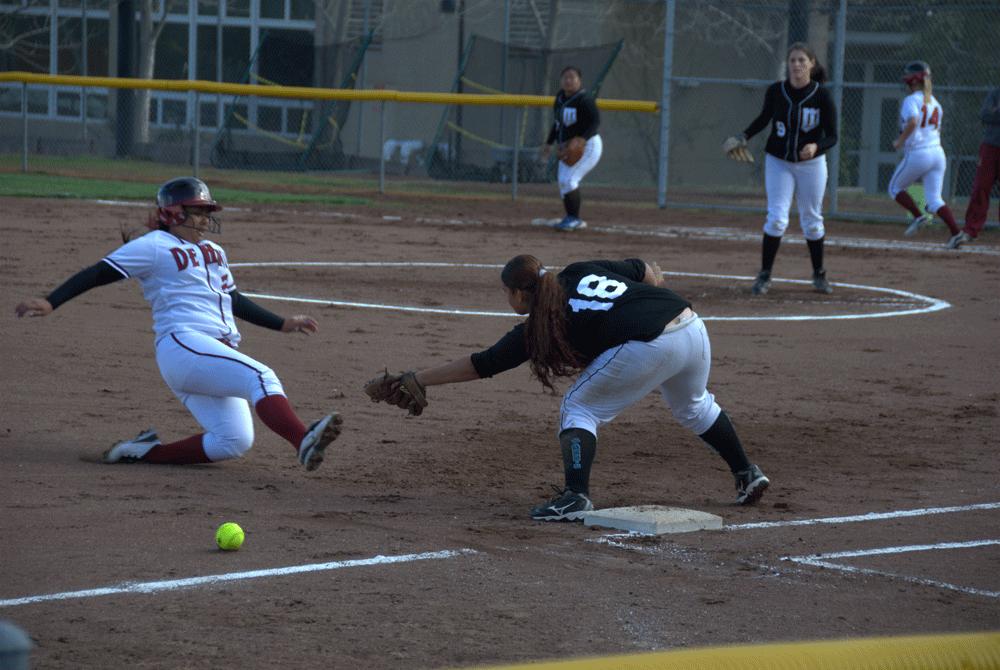 SAFE BY A SECOND - Marianne Llavore slides into third past an overthrown ball, which resulted in another run for the Dons.