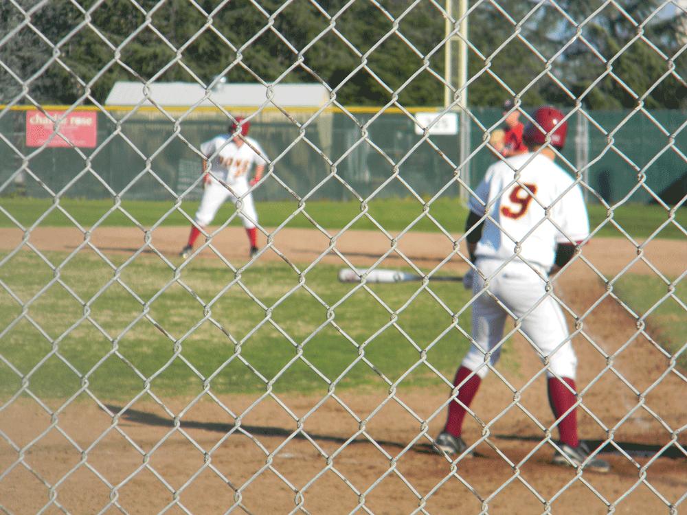 THIEF! - Mark Milioto (9) is up to bat while Chris Stavrenos (27) is ready to take second base.