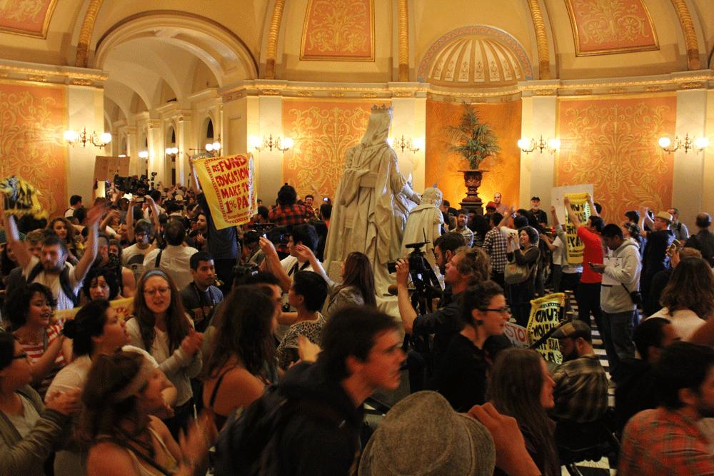 OCCUPY SACRAMENTO - Protestors in the Capitol rotunda chant and dance around Columbus Last Appeal to the Queen Isabella statue on March 5.