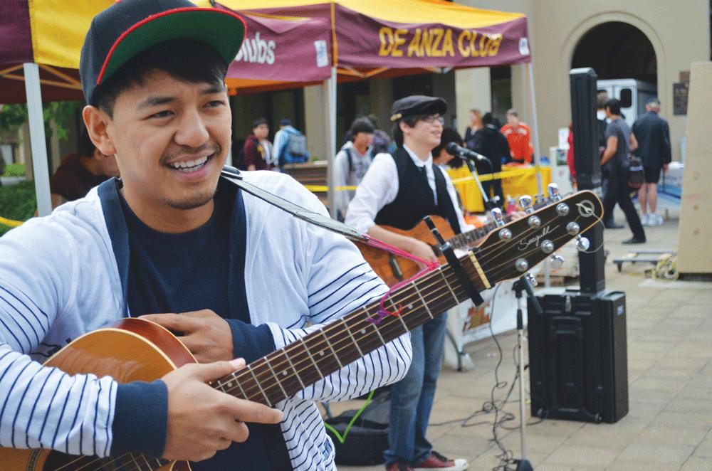SONG STYLES - Anthony Bunales, nursing major, prepares for his performance following William Wang, 18, in the main quad in front of the Club Day crowd.