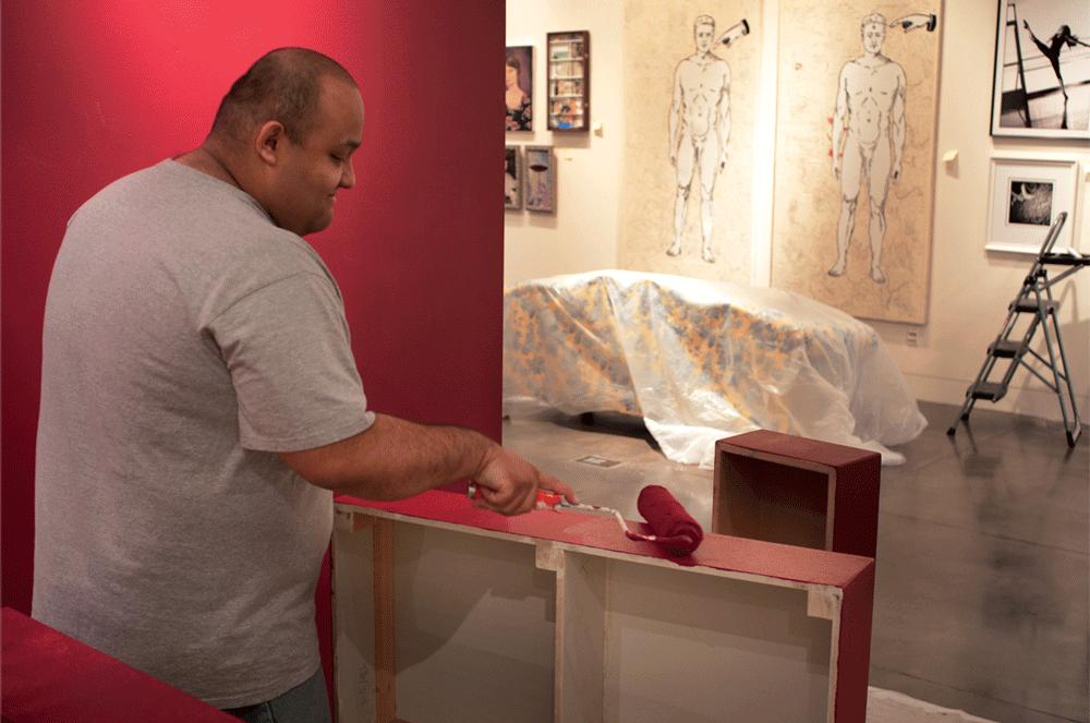 FINISHING TOUCHES - Israel Sanchez,an administration of justice major, helps set up for the Student Art Show in the Euphrat Museum of Art. 