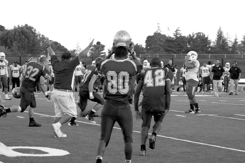 VICTORY CELEBRATION - Coaches and players run to the field as De Anza beat San Mateo, 46-43