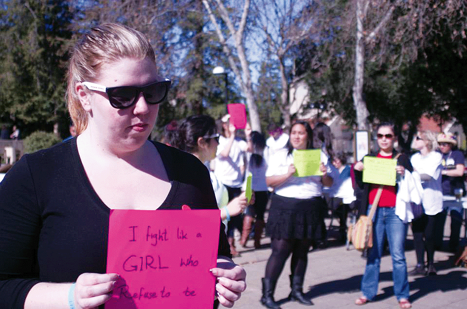 ACTION FOR A CAUSE - Shani Haven, 25, holds a sign to fight for the respect women deserve.