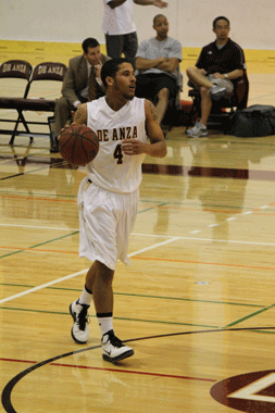 SETTING UP PLAY - Sophomore point guard George Henderson (4) dribbles down the court on Feb. 8 as De Anza College played against Cabrillo College. 