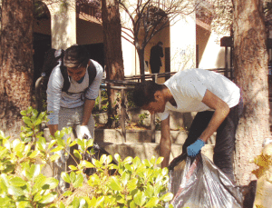 CAMPUS CLEANUP - De Anza student Oliver Celara (left) and DASB senator Ryan Royster (right) look for trash by the Hinson Campus Center during the campus cleanup on March 13.