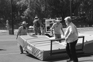 Joe Cook, far right, and Reyes Hernandez, far left, move mats near De Anzas athletics track.