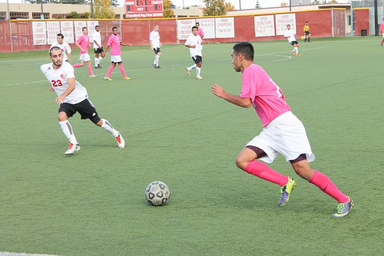 Freshman foward Bobak Ohadi (18) attempts to get past Serta Gemici (23) Tuesday, Oct. 29 against Foothill College.