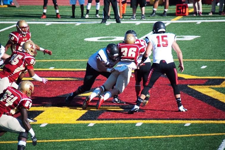  Linebacker Brandon Martinez (36) smells the run and tackles Owls running back Anthony Munoz (23). 