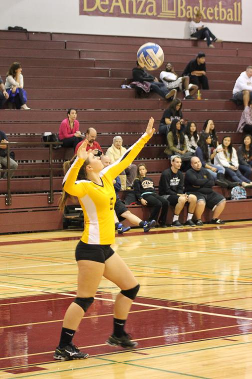 Freshmen defensive specialist Kelly Baxter (5) serves the ball during the second set against San Jose City College Wednesday Oct 23.