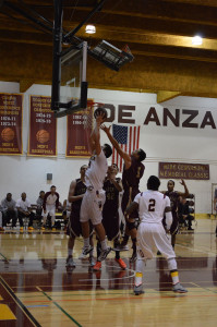 Sophomore post Jack Pasquini (34) goes for a two-handed layup while avoiding the block attempt from Hartnell defender Darius Wright (1).