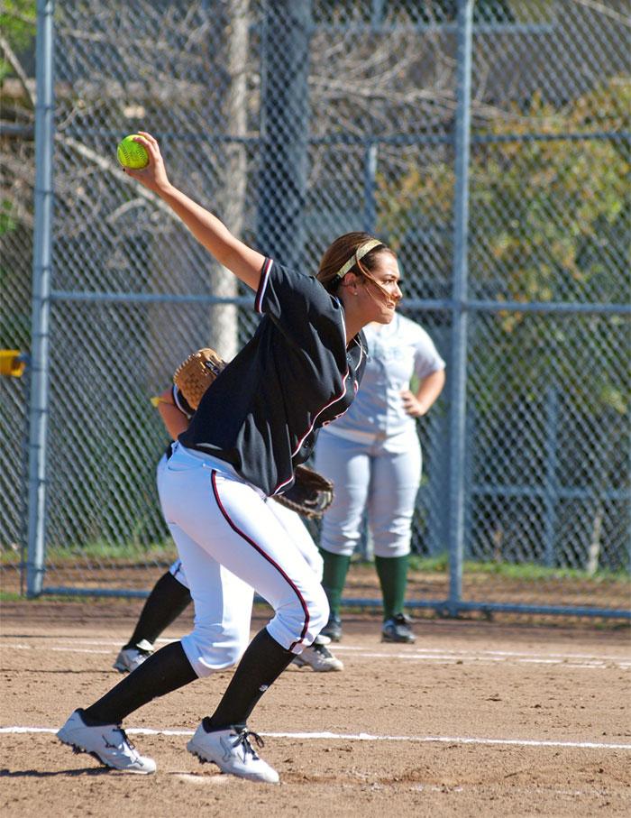Freshman right-handed pitcher Lauren Matias (13) winds up to throw a pitch. Matias pitched a complete game giving up only two runs in the Dons 6-2 victory on Thursday March 13.