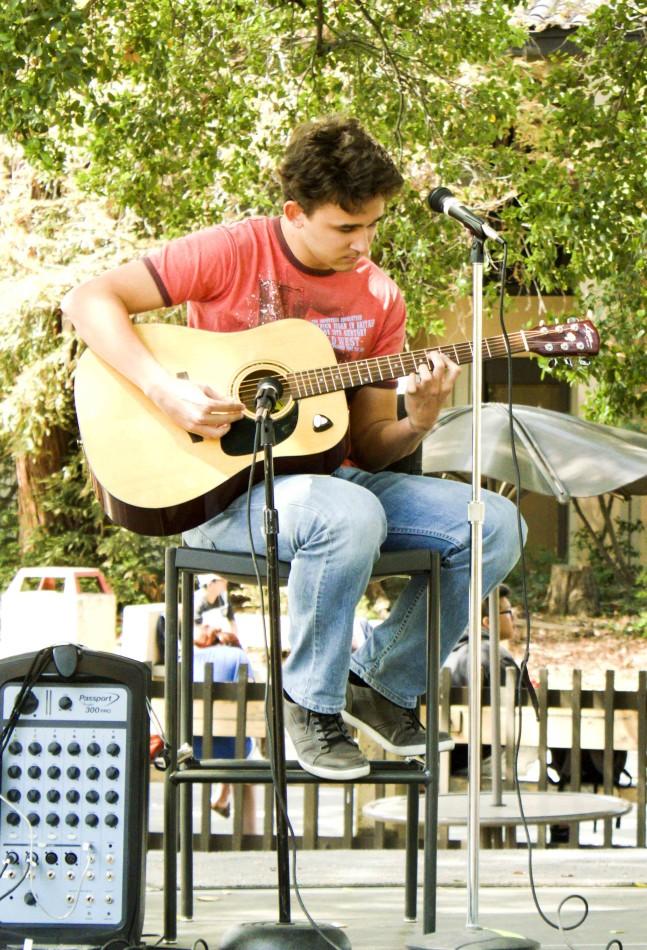 Artem Zinin, 20, electrical engineering major, performs Stairway to Heaven by Led Zeppelin in the Welcome Week Open Mic event on April 9 in Main Quad at De Anza College. 
