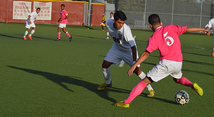 De Anza College freshman midfielder Javier Ceballos (5) stands over the ball trying to get around a Gavilan College defender.  The Dons bounced back from their first loss of the season with a 4-0 win on Friday Oct. 24