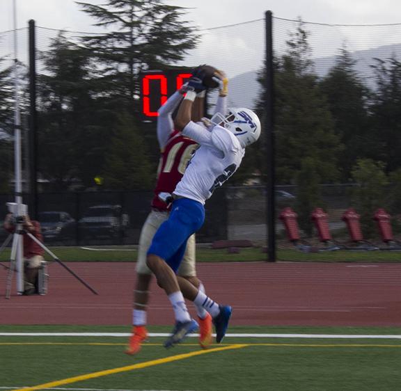De Anza sophomore wide receiver Ismail Shafi battles for possession of the ball with a College of San Mateo player. The Dons suffered a 61-14 defeat on Saturday Oct. 25.