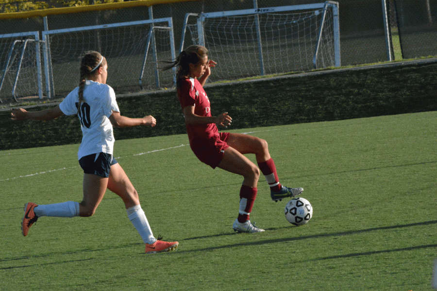 Freshman Hanh-Uyen Doan (5) protects the ball from an oncoming West Valley player.