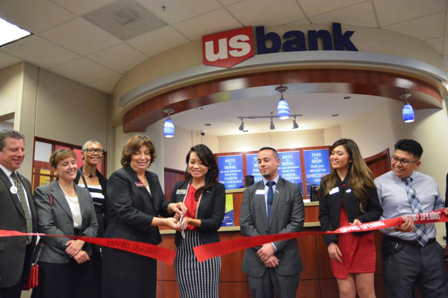 Bookstore director Kelly Ann Swanson (left) and US Bank branch manager Hannah Nguyen cut a ribbon to celebrate the grand opening.