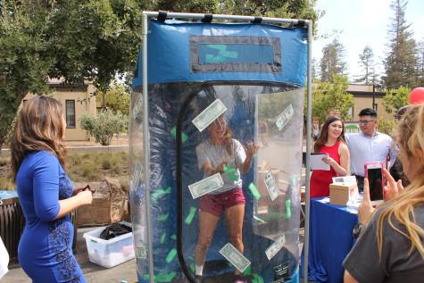 Students grab for coupons at U.S. Bank's Booth in the main quad on Thursday, Oct.8.