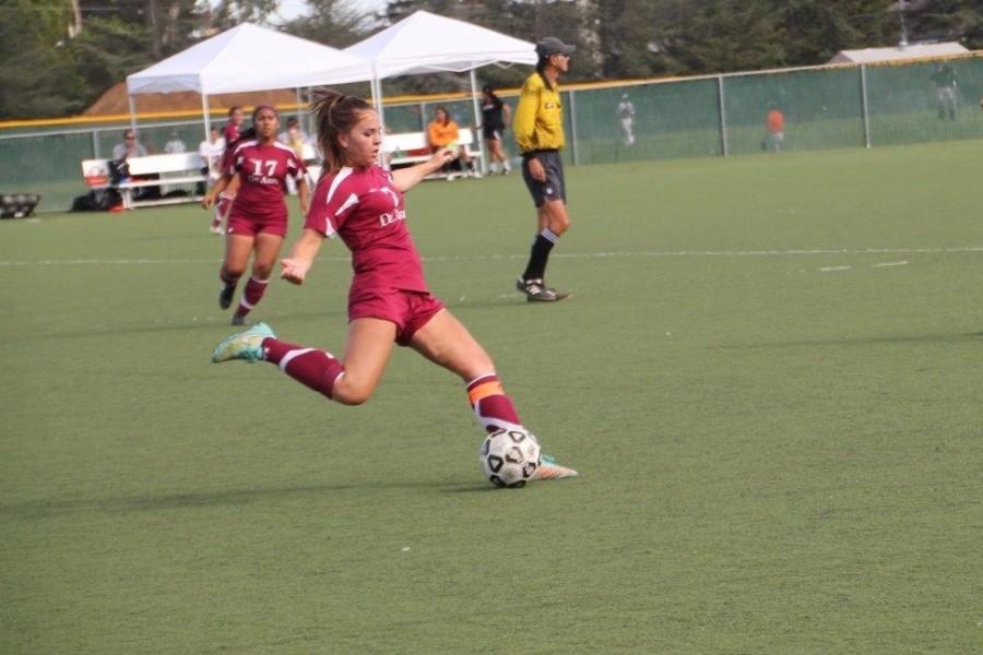 Midfielder Kelly Baxter (7) strikes the ball in the Dons’ Sept. 25 loss to the Skyline