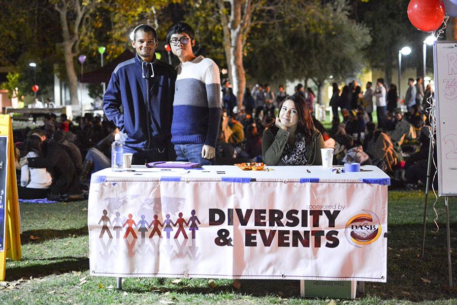 (left to right) Konrad Melbinger, 21, DASB vice chair of technology, Chung Heng, 19, computer science major and Anastasia Levchenko, 18, DASB chair of diversity & events man a table to hand out tickets for free pizza and hot chocolate.