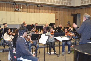 Music director Loren Tayerle (far right) instructs orchestra students during a rehearsal on Thursday, Nov. 19.