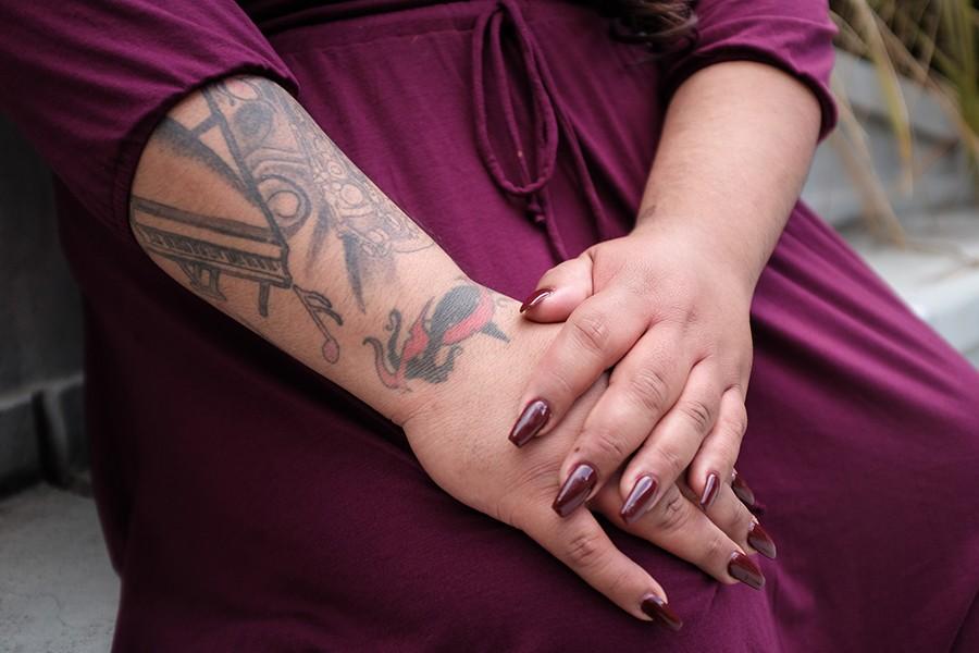 Ruby Mendoza shows her tattoo that she said represents her love for music