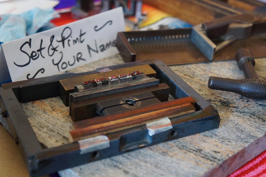 Tools to set and print names are scattered at the table. They come in many fonts and colors.