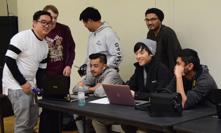  The tournament officials register players, call out rounds and joke around with some of the competing students at De Anza’s fireside lounge Nov. 30.
