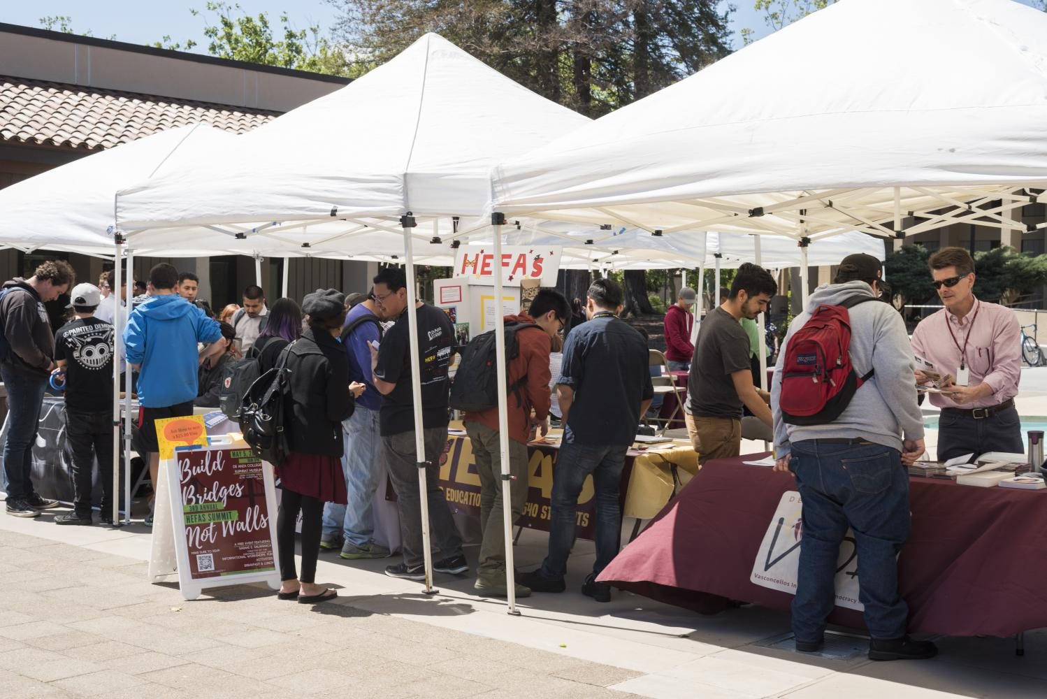 Students crowd around the Higher Education For AB 540 Students and Vasconcellos Institute for Democracy in Action booth to learn more about the organizations during the VIDA Project Fair on April 20