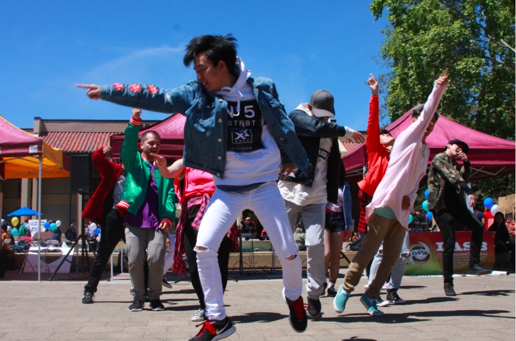 One of the many performances of the day, the K-Pop Dance Club is seen here enthusiastically dancing. The club hoped to excite their audience and bring new members to their organization by showing off their dancing abilities. 