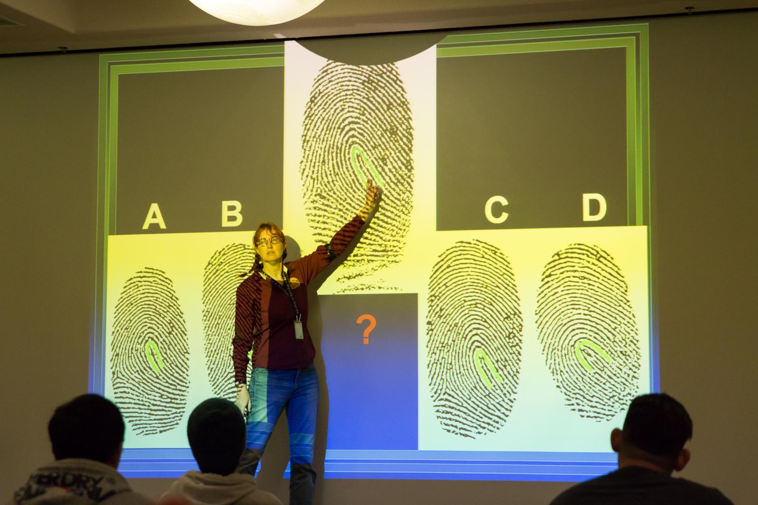 Willis shows the audience how they label evidence at a crime scene in Palo Alto, CA.
