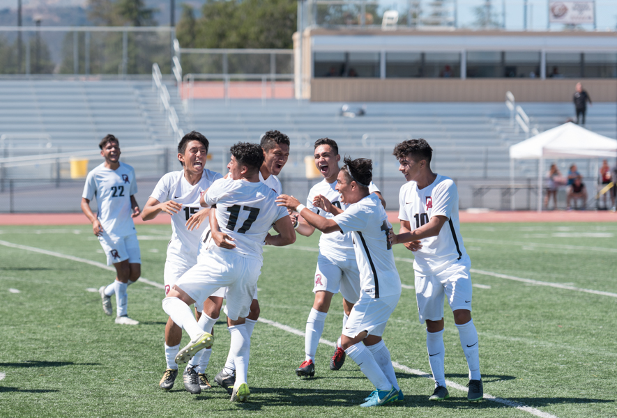 Dons celebrate a last-minute goal that broke a tie and led let the to a 3-2 victory over Lassen College Sept. 19