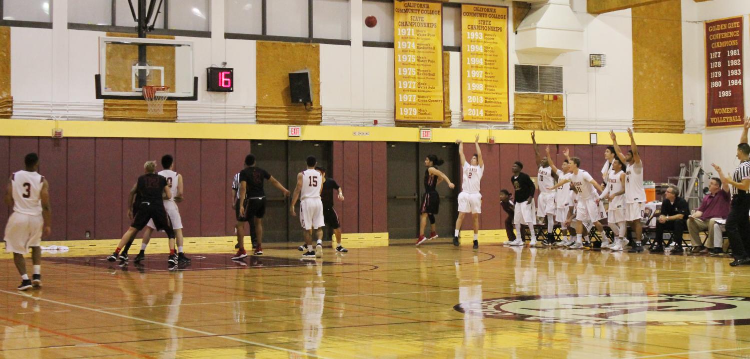 De Anza guard Blake Uyehara drives toward the rim and attempts to finish as De Anza guard Austin Yvanovich boxes out in preparation for a potential rebound.