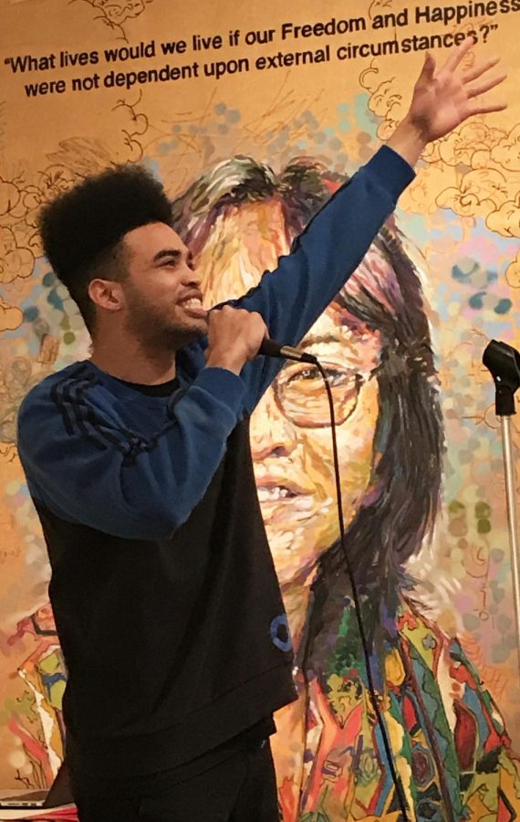 Tyrone Powell, known as MC Black Jesus, extends himself to the crowd at the Feb.1 First Thursday open mic in the Euphrat Museum.