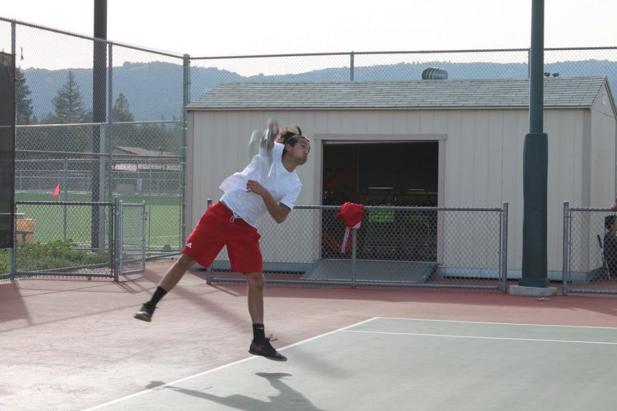De Anza College mens tennis player Evan Gazikian serves during his singles match.