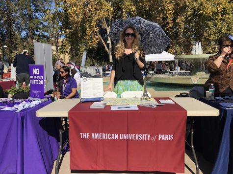 Jen Boucher, representative for The American University of Paris stands by the universitys booth during Transfer Day. You can see the Eiffel Tower from our school! Boucher said to passing students. 