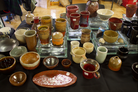 An assortment of handmade cups line the ceramics table in the Campus Center on Dec. 5.