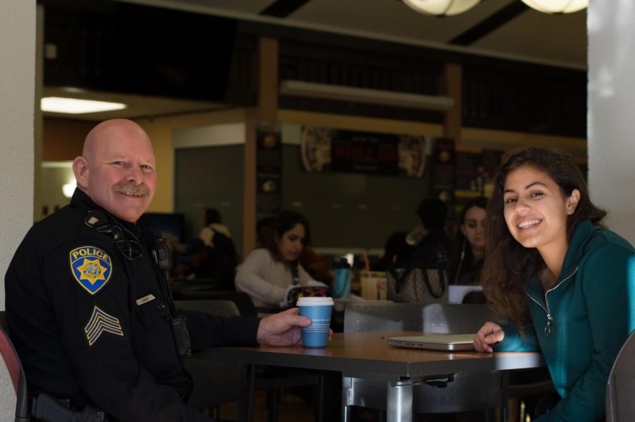 Police officer Jeff McCoy and Giselle Manzanares, 18, criminal justice major finish their conversation in the De Anza College main dinning hall on Feb. 5