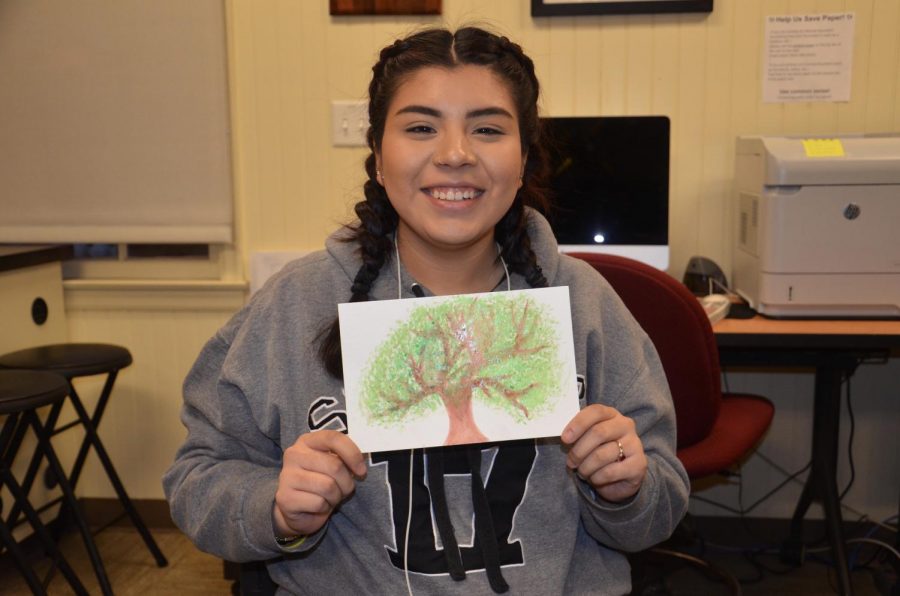 Jocelyn Lopez, 19, criminal justice major, with a paining shat made during the self-care event on Feb. 14.