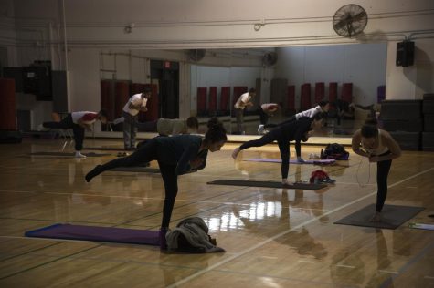 Flow Yoga course instructor Danielle Altman leads students in poses on March 12.