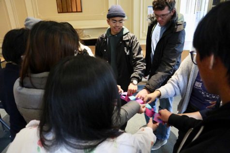 Students end the Chain of Oppression together by ripping strips apart.