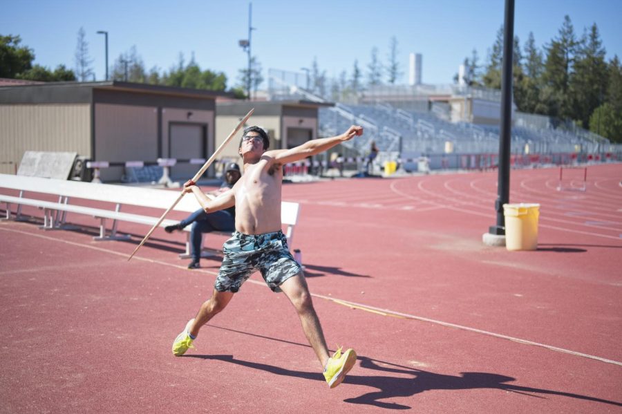 Mid-distance runner and javelin thrower Emilio Zertuche, 19, film and television production major practices the javelin at the De Anza track on April 22.